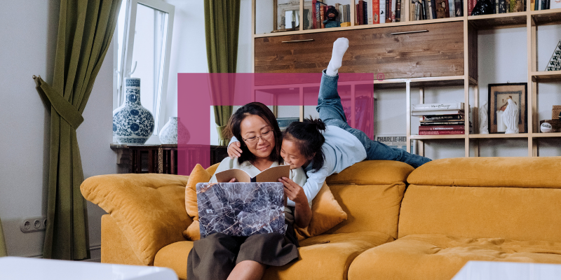 mortgage-borrower-reading-story-to-daughter-on-living-room-couch
